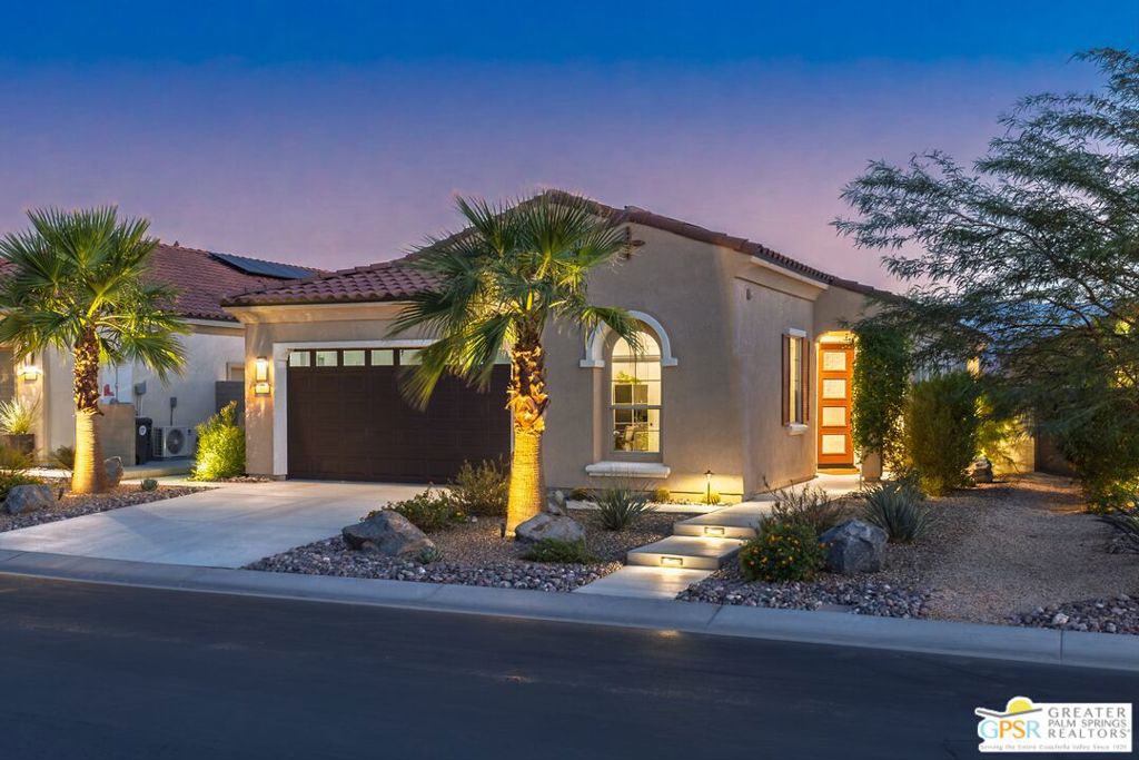 This beautifully upgraded home showcases nearly $250K in thoughtful enhancements, designed to elevate every aspect of modern living. The low-maintenance landscaping creates a warm welcome, leading you to a sun-filled entry with gleaming tile floors. Inside, the open-concept layout seamlessly connects the kitchen, dining, and living areas for effortless flow and entertaining. The kitchen is a chef's delight, featuring quartz countertops, illuminated custom cabinetry, a striking backsplash, walk-in pantry, and premium appliances. Every upgrade has been intentionally chosen from LED lighting and extra storage to electronic window treatments and Wi-Fi extenders, all to enhance convenience and comfort. The primary suite offers direct patio access, and its spa-like bathroom boasts elegant finishes and fixtures for a truly relaxing retreat. Experience resort-style living in this premier 55+ community, where amenities abound: two sparkling pools, spa, tennis and pickleball courts, bocce ball, a ballroom, lounge, bar, and more. Residents enjoy a fitness center with yoga and group classes, a golf simulator, an outdoor fireplace, miles of walking paths, and a robust calendar of social events. Mission Hills Golf Club is just across the street, and you're minutes from downtown Palm Springs with easy access to dining, shopping, entertainment, healthcare, and major freeways. This is the ideal setting for a vibrant, balanced lifestyle focused on enjoying life to the fullest.