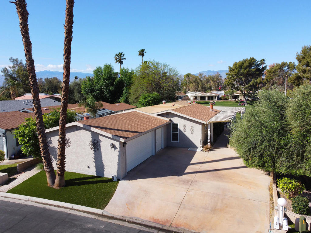 Beautiful, well-maintained home with stucco exterior, offers an expansive views of golf course and mountains from oversized patio. 3 car garage with separate golf cart door facing a driveway that easily holds 4 vehicles. Enter the front door to the living room with a wide open view of the kitchen and adjoining family room on the other side of the kitchen. Two separate dining areas in the family room plus seating at the quartz countertop in the kitchen. Stainless steel appliances are a feature in this sizable kitchen designed for easy meal prep. Laundry room is loaded with storage and leads to the hallway for the guest bedroom and bathroom with the master bedroom/bath situated at the end against the garage wall easily buffering outside noise. Owner upgrades include all vinyl flooring, custom kitchen cabinetry with soft-close doors and new double pane windows and shutters throughout. Ivey Ranch has a par 3 golf course, tennis/pickleball courts, clubhouse, exercise equipment room, and 4 pools w/2 spas.Gated with guard on duty till 3 pm daily.