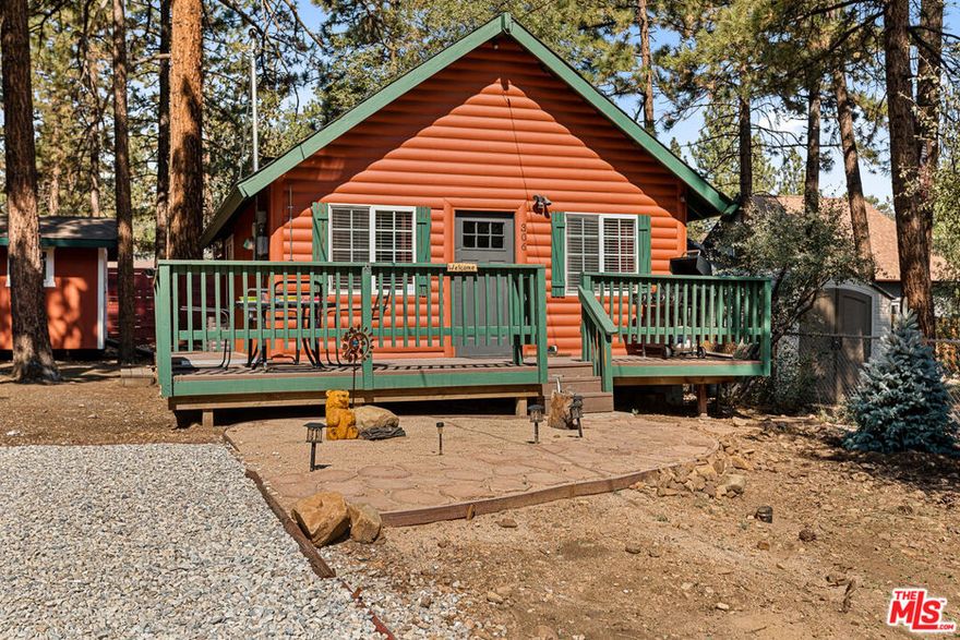 This idyllic cabin (Calipe Cottage) is the quintessential mountain cottage set amongst majestic trees. The house has been lovingly renovated in full and delightfully finished. This cozy property has a relaxing bedroom, a sleeping loft, with a chic bathroom featuring a steam shower and fully equipped designer kitchen. It is a magical retreat for those escaping the hustle and bustle of City Life. Arriving at the home, the large 5,000 sqft lot provides ample parking. The expansive front and wrap-around porch is the perfect spot to indulge in alfresco dining and entertaining your family and friends. Upon entering the home, you will note the living room has high vaulted ceilings and recessed lighting. The bright kitchen has plenty of storage, quartz countertops and all appliances including a stackable washer / dryer. The cozy loft with its king-size bed is a delightful space for a deep sleep. The main bedroom has access to a quiet rear terrace, where a soak in the spa is the perfect way to unwind. The house is being sold fully furnished, turnkey. It is tranquil and filled with natural light. The home features two electric fireplaces setting the ideal ambiance no matter the weather outside. Fully equipped with air conditioning and heating, Ring and cameras. Perfect as a family retreat, a getaway for friends or a wonderful vacation rental that's ready immediately. Minutes to all that Big Bear has to offer, dining, hiking, biking and lake activities. A very short drive will see you on the slopes of Snow Summit and Big Bear Mountain Ski Resort. What better way is there to unwind after an adventurous day than at this magical property surrounded by the serene sights and sounds of nature?