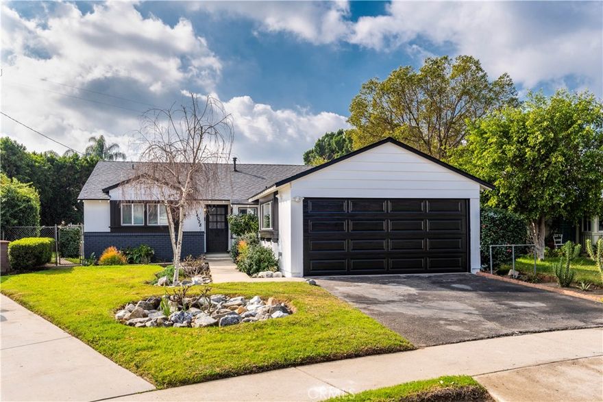 Beautifully remodeled ranch-style home featuring three spacious bedrooms and two updated bathrooms. Centrally located in a charming neighborhood, this residence offers a bright, open floor plan with expansive living and dining areas. The inviting living room showcases a brick corner fireplace, while the oversized den opens to the backyard through sliding glass doors. Enjoy a sunlit galley kitchen complete with a breakfast nook, newer shaker cabinets with soft-close hardware, quartz countertops, a subway tile backsplash, and a premium stainless steel appliance suite, including a range, microwave, dishwasher, and refrigerator. Adjacent to the kitchen, a cozy service porch offers flexibility as a small office space. All bedrooms are generously sized, and both bathrooms have been remodeled with modern quartz finishes and classic subway tile accents. The backyard features a covered patio and a meticulously maintained grassy lawn, perfect for outdoor relaxation. Additional highlights include vinyl plank flooring and recessed lighting throughout. This stunning property is a must-see!