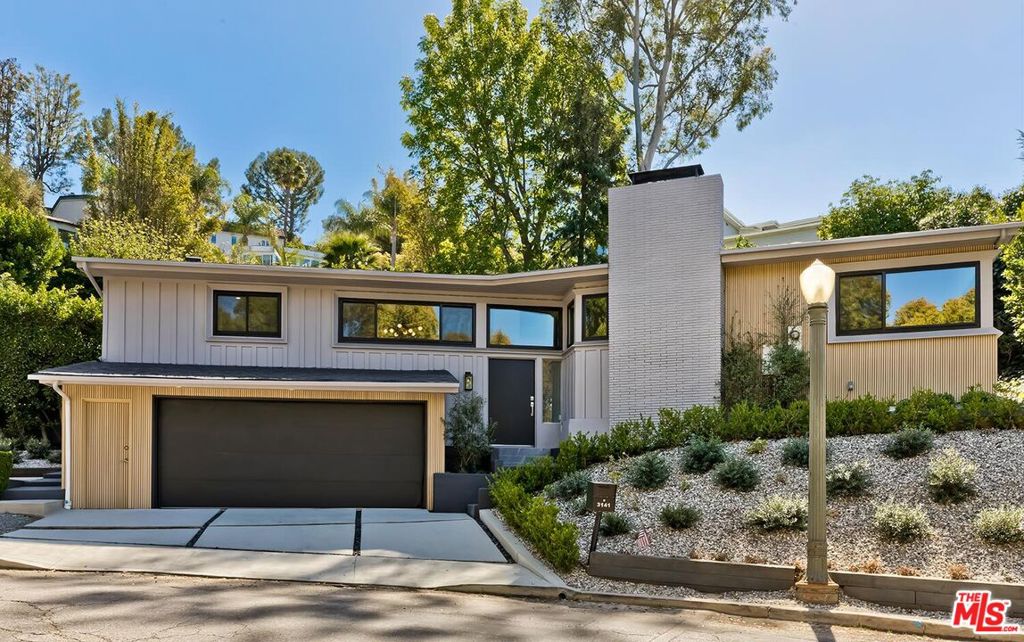 Stunning and dramatic Contemporary Remodeled Pool/view home in Lake Hollywood - Located in the highly sought-after Lake Hollywood Knolls neighborhood and on one of the most appealing streets, this dramatic contemporary home features a spacious great room with vaulted-beamed ceilings, a fireplace, skylights, and newer Anderson Windows that showcase the treelined views from every window! The huge living room can accommodate an office and opens to the dining area, kitchen, and den. The elegant kitchen features all-new stainless steel appliances, quartz countertops, cabinets, and a chevron-design tile backsplash. The refrigerator is Wi-Fi enabled with a video screen and too many features to mention. The den/family room is cozy and opens to the backyard (It could also serve as a 4th bedroom). It is ideally located beside the kitchen, and the 3/4-bath perfectly serves the den and swimmers coming in from the pool area. All three bedrooms are slightly elevated above the living area. The primary suite has ample closet/storage space, beautifully remodeled, a tub, and a separate shower. The guest bedrooms are adjacent to the primary suite, with good closet space/storage and a stunning Quartz bathroom with a walk-in shower. Outdoor living is at its best, with an entertainer's backyard boasting a large pool, with plenty of room to BBQ, relax, sun, or read a book, all in privacy. Lake Hollywood is centrally located next to Universal Studios, Warner Bros, Disney Studios, The Hollywood Bowl, hiking trails, The Lake, the dog park, and 5 minutes close to Ralphs, Vons, Trader Joe's, Whole Foods, and good restaurants.