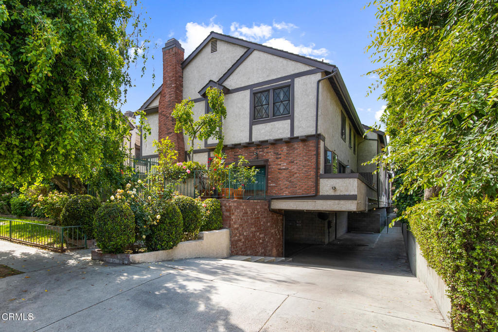This stylish and well-appointed Valley Village townhome features an updated kitchen with stainless steel appliances and a new tile backsplash, a convenient laundry area, and a half bath on the main level. The spacious living room is anchored by a large fireplace and filled with natural light from a sliding glass door that opens to a private balcony. Upstairs, you'll find two en suite bedrooms with updated tile floors and modern fixtures. The home includes two assigned parking spaces in a secure subterranean garage, along with guest parking for visitors. HOA amenities include a covered patio perfect for gatherings and a large hot tub for relaxing after a long day. With its prime location and easy access to nearby studios and entertainment hubs, this move-in-ready property is a smart and stylish choice.