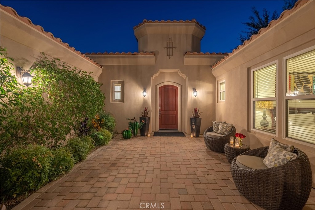 Welcome to your desert oasis, a luxurious 4,000 sq. ft. retreat with breathtaking western views of the Santa Rosa Mountains. This stunning home, located on the 6th tee box of the prestigious Greg Norman Resort Golf Course in PGA West, features four bedrooms and four-and-a-half bathrooms, offering panoramic vistas of the mountains and fairway.
As you enter through a private gated courtyard on this corner lot, you'll enjoy complete seclusion from the outside world. The home showcases retractable glass walls along the entire back, seamlessly blending indoor and outdoor living spaces. You'll find a Life Source water filtration system providing pure water throughout the home, including the pool.
The gourmet kitchen is a chef’s delight with granite countertops, stainless steel appliances, dual ovens, a microwave, dishwasher, and an 8-burner gas stove. The expansive island with seating for five is ideal for socializing while preparing meals, and there's additional seating for six at the kitchen table. For more formal dining, the separate dining room accommodates ten guests.
The open floor plan allows for easy relaxation in the family room, which includes an oversized sectional sofa, a fireplace, and a 70" HDTV with Roku and Apple TV. The bar area, featuring seating for four and a Margaritaville Margarita Machine, is perfect for entertaining. Both the family room and kitchen open up to the pool area through retractable glass walls, bringing the beauty of the outdoors inside.
Unwind by the tranquil saltwater pool and spa, which includes a waterfall and a built-in tanning shelf. Relax under the covered patio with misters and an outdoor living room, or enjoy the evening by the outdoor fireplace. The outdoor space offers six chaise lounges, multiple umbrellas, and a built-in natural gas BBQ.
Each bedroom has its own en-suite bathroom, and two bathrobes are provided per bedroom. The master suite features a Cal King bed, a fireplace, a spacious seating area, and patio access with views of the fairway. The master bath includes a walk-in shower with dual showerheads, dual sinks, a vanity area, a large soaking tub, and an oversized walk-in closet.
Bedrooms 2 and 3, located on opposite sides of the main house, each offer a Cal King bed, a walk-in shower, and two bathrobes per room.
The detached casita, includes a large sitting area with a pull-out sofa and a TV, plus a fourth bedroom with a Cal King bed and its own en-suite bathroom.
