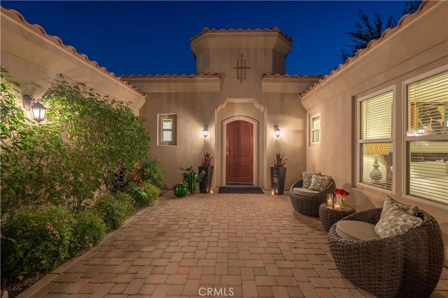Welcome to your desert oasis, a luxurious 4,000 sq. ft. retreat with breathtaking western views of the Santa Rosa Mountains. This stunning home, located on the 6th tee box of the prestigious Greg Norman Resort Golf Course in PGA West, features four bedrooms and four-and-a-half bathrooms, offering panoramic vistas of the mountains and fairway.
As you enter through a private gated courtyard on this corner lot, you'll enjoy complete seclusion from the outside world. The home showcases retractable glass walls along the entire back, seamlessly blending indoor and outdoor living spaces. You'll find a Life Source water filtration system providing pure water throughout the home, including the pool.
The gourmet kitchen is a chef’s delight with granite countertops, stainless steel appliances, dual ovens, a microwave, dishwasher, and an 8-burner gas stove. The expansive island with seating for five is ideal for socializing while preparing meals, and there's additional seating for six at the kitchen table. For more formal dining, the separate dining room accommodates ten guests.
The open floor plan allows for easy relaxation in the family room, which includes an oversized sectional sofa, a fireplace, and a 70" HDTV with Roku and Apple TV. The bar area, featuring seating for four and a Margaritaville Margarita Machine, is perfect for entertaining. Both the family room and kitchen open up to the pool area through retractable glass walls, bringing the beauty of the outdoors inside.
Unwind by the tranquil saltwater pool and spa, which includes a waterfall and a built-in tanning shelf. Relax under the covered patio with misters and an outdoor living room, or enjoy the evening by the outdoor fireplace. The outdoor space offers six chaise lounges, multiple umbrellas, and a built-in natural gas BBQ. 
Each bedroom has its own en-suite bathroom, and two bathrobes are provided per bedroom. The master suite features a Cal King bed, a fireplace, a spacious seating area, and patio access with views of the fairway. The master bath includes a walk-in shower with dual showerheads, dual sinks, a vanity area, a large soaking tub, and an oversized walk-in closet.
Bedrooms 2 and 3, located on opposite sides of the main house, each offer a Cal King bed, a walk-in shower, and two bathrobes per room.
The detached casita, includes a large sitting area with a pull-out sofa and a TV, plus a fourth bedroom with a Cal King bed and its own en-suite bathroom.
