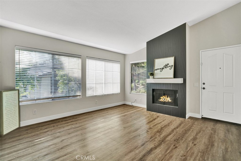 Beautifully Upgraded Upstairs End Unit with Views of the Greenbelt! This gorgeous 2 bedroom and 2 bathroom home boasts laminate wood flooring, stone accent fireplace, tall ceilings, a balcony with open views of the greenbelt, inside laundry, one car detached garage and more! The spacious remodeled kitchen includes Quartz countertops, stainless steel appliances, black granite composite sink and plenty of storage. The bedrooms are large with tall ceilings and the primary bedroom includes a primary bathroom and walk-in closet. Enjoy the beautiful resort-style pool and spa, nearby parks, hiking/biking trails and close to restaurants and shopping. Don't miss out on this amazing home!