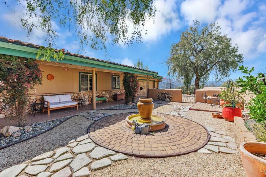 Discover a tranquil haven in this beautiful two-story home nestled in oak groves and sunny grass uplands. Set within a panoramic mountain vista, it overlooks vineyards and picturesque valleys and is a seamless fusion of rustic charm and modern comfort. Its driveway leads you through a mix of wildness and meticulously maintained parkland, exhibiting a harmonious balance between nature and refined living. The property boasts elegant exterior spaces and combines classic red tile roofing with Hardie Siding walls and a distinctive stone base. This blend creates a warm, inviting atmosphere where a rustic patio and covered porch serve as a perfect sanctuary. Indoors, the elegance continues with extensive stonework and two cozy fireplaces that form the heart of the home. The wrap-around deck overlooks enchanting daytime scenes of the Cachagua Valley and offers a front-row seat to view the Milky Way in the spectacular nighttime sky. Positioned in the esteemed Asoleado Estates gated community, this home is more than a residence; it's an invitation to a lifestyle with magnificent beauty and peaceful harmony. Whether savoring morning coffee or entertaining guests against the backdrop of the Santa Lucia Mountains, this property offers an unrivaled experience of luxury and natural splendor.