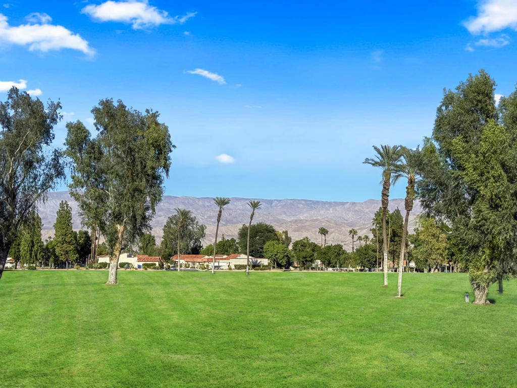 Located in the heart of Palm Desert, this beautifully updated 2 bedroom, 2 bath condo in the Palm Desert Resorter captures the essence of desert living. Enjoy fabulous east-facing fairway and mountain views from the extended covered patio, perfect for morning coffee or relaxing evenings. The kitchen has been opened up to create a bright, inviting space with new cabinetry and a seamless flow into the living area. Both bathrooms have been tastefully updated, and the home features tile flooring throughout except planked vinyl flooring in the bedrooms for a warm, modern touch. A 2-car garage has been added for convenience and additional storage. Experience resort-style living at its best with golf, tennis, pickleball, bocce ball clubhouse amenities, 20 pools and spas and a vibrant social atmosphere--all within the gates of this sought-after Palm Desert community. Short term rentals are allowed.