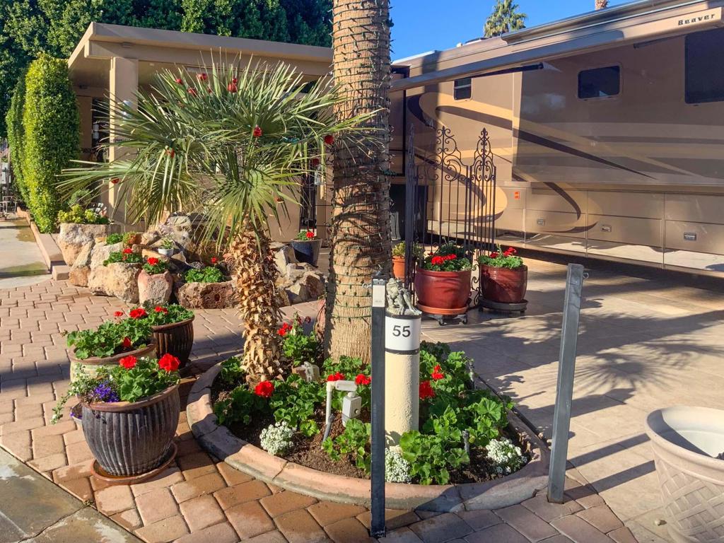 An elegant Alumawood pergola shelters a spacious outdoor kitchen, perfectly positioned to capture sweeping views of the golf course. This luxury RV lot is thoughtfully designed for both comfort and entertainment, featuring an expansive kitchen with stainless steel appliances, an entertainment center, and a mobile bar. The outdoor living area is beautifully finished with tiled flooring and pavers, complemented by custom covers and stylish furnishings.A striking waterfall feature, enhanced by ambient lighting, sets the tone for unforgettable evenings. Four built-in heaters, three ceiling fans, and electric shades ensure comfort, whether you're enjoying a peaceful night alone or entertaining guests under the stars.Privacy abounds with no neighbors on one side and a mature shade tree that offers charm and natural cover. When trimmed, it reveals an unobstructed, breathtaking view of the golf course--making this lot truly one of a kind. Additional highlights include mid-lot hookups, ample space for relaxation, and a layout that balances elegance, functionality, and serenity.‍Outdoor Resort Indio is a class A only RV resort in Indio, CA.