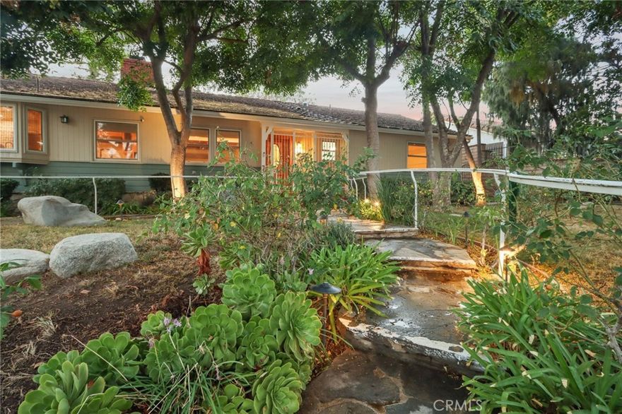 Charming Ranch-Style Retreat in the Heart of Old Granada Hills.  Nestled in a picturesque Granada Hills neighborhood, this beautifully maintained single-story ranch home offers timeless character, thoughtful updates, and incredible potential. Situated on an expansive 14,927 sq ft lot, this 4-bedroom, 4-bath home spans 2,271 sq ft of inviting living space—perfect for entertaining, relaxing, or expanding your vision.  Step inside to discover a light-filled kitchen adorned with granite countertops, travertine backsplash, stainless steel appliances, a built-in refrigerator, and a charming bay window. The spacious eat-in area flows effortlessly into a formal dining room, ideal for hosting family and friends.  The warm and inviting living room is the heart of the home, featuring stunning wood-beamed ceilings, a classic marble fireplace, and elegant French doors that open to your private backyard escape. With four generously sized bedrooms, including two en suites, there’s room for everyone to unwind. The primary suite is a true sanctuary with a walk-in closet, French doors to the backyard, and a luxurious bath complete with a soaking tub and separate shower.  A dedicated indoor laundry room adds modern convenience, while original details and tasteful upgrades preserve the home’s unique charm.  Outside, the possibilities are endless. Entertain year-round under the expansive 660 sq ft L-shaped covered patio, enjoy cozy evenings around the gas firepit, or soak in the rock spa under the stars. The huge backyard is a blank canvas—whether you envision lush gardens, a pool, or a playground, there’s space for it all.  Looking for more flexibility? The detached two-car garage, complete with an additional storage room or den, offers fantastic ADU or guesthouse potential. Located in the highly sought-after Granada Hills Charter High School district and just moments from the beloved Granada Hills Farmers Market, shops, and dining, this home combines comfort, character, and convenience in one incredible package.  Don’t miss the opportunity to create your dream lifestyle in this one-of-a-kind Granada Hills gem!