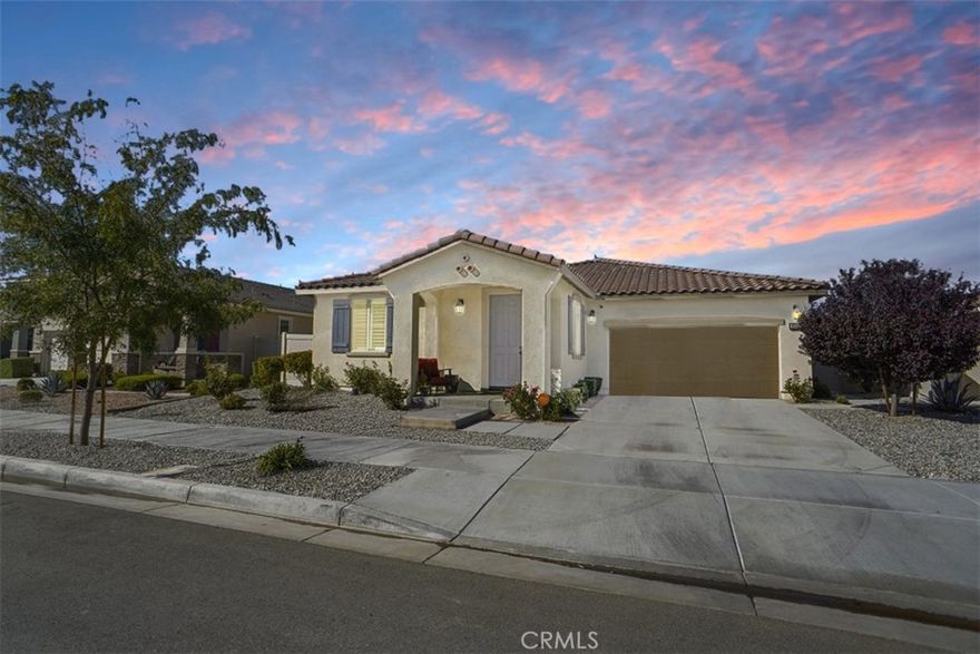 Stunning Single-Story Home with 30 Paid Solar Panels! This immaculate residence shows better than a model home and offers exceptional comfort and energy savings. Step inside to find luxury laminate flooring throughout the main living areas and plush carpeting in all bedrooms. The gourmet kitchen features elegant quartz countertops, a massive center island, a stainless steel 5-burner range, dishwasher, and microwave—perfect for cooking and entertaining. The open-concept floor plan is enhanced by wide hallways and a spacious family room, ideal for gatherings. Every bedroom includes a walk-in closet, and the home is packed with premium upgrades such as a tankless water heater, upgraded molding, plantation shutters, modern ceiling fans, designer light fixtures, and warm earth-tone colors. Step outside to a beautifully landscaped backyard with a large patio slab and covered patio, offering the perfect outdoor living space. With 30 owned solar panels, this home is not only beautiful but smart—delivering monthly cost savings and efficiency. This is a true turnkey home—elegant, energy-efficient, and ready to impress.