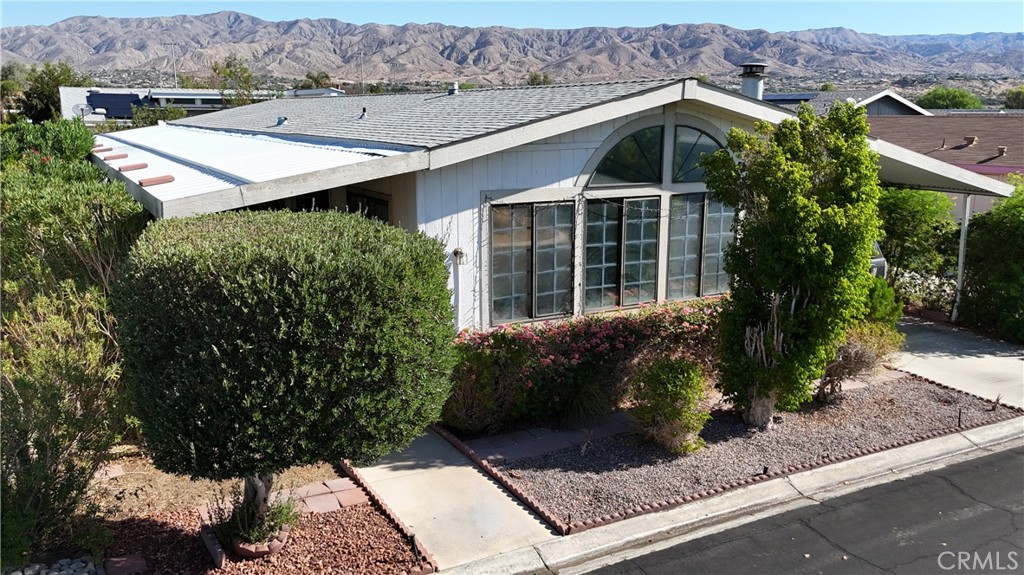 Welcome To Your New Desert Retreat! This Charming Home Is Located In The Gated Vista Montana 55+ Community, Offering Residents A Peaceful Lifestyle With Well Kept Grounds, Mountain Views, Resort Style Amenities, And Privacy And Security With A Guard At The Gate!
Discover Comfort And Value In This Inviting Residence Close To The Vista Montana Clubhouse. This Well-Maintained Home Welcomes You With A Charming Drought-Tolerant Landscape, Mature Hedges, And A Stunning Arched Front Window That Fills The Living Area With Natural Light.
Step Inside To A Spacious, Open-Concept Living And Dining Area Featuring Updated Wood-Style Flooring, Striking Wood-Beamed Vaulted Ceilings, And A Cozy Stone Fireplace For Relaxed Evenings At Home. Beautiful Built-In Cabinetry And A Mirrored Hutch Provide Both Style And Storage, Ideal For Displaying Treasured Keepsakes.
Enjoy An Eat-In Kitchen With Generous Counter Space, Plentiful Cabinetry, And A Sunny Breakfast Nook Perfect For Morning Coffee. The Master Suite Offers Ample Room To Unwind, Mirrored Closet Doors For Extra Storage, And Direct Access To A Spacious Bathroom With Double Vanities And Abundant Natural Light.
Residents At Vista Montana Enjoy Resort-Like Amenities Including A Pool, Spa, Clubhouse, Fitness Center, Pool Tables, And A Large Banquet Hall With A Commercial-Style Kitchen—All Within A Secure, Gated Setting. Conveniently Situated Near Shopping, Dining, And Local Attractions, This Home Is Priced To Sell And Ready For Immediate Enjoyment! Palm Springs Is 10 Minutes Away, And The 10 Freeway Is 5 Minutes Away. Not Far From The Mountains, Orange County, LA County, And Your Favorite Arizona Destinations! Come See This Before It's Too Late!