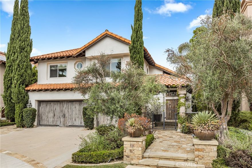 Lease a luxury fully furnished, Hillside sanctuary with forever sunset views. Life unfolds gracefully in this private view residence, positioned at the end of a cul-de-sac in prestigious Marina Hills. Set on a single-lined street with no direct neighbors front or back, the property commands an exceptional vantage point, facing open green space and backing to expansive western views that capture sunset colors over rolling hills. Arrive on a gated stone path to the covered entry and new oak double doors. Inside, a double-height foyer sets the tone for the home's grand proportions. The interior blends luxury amenities and updates with a soothing natural palette, including new oak floors, linen shades throughout, and water features off the entry and kitchen, inviting calm and relaxation in every space. The formal living room, anchored by a stately fireplace, opens to a dining space that captures miles of natural vista through generous windows. The chef’s kitchen attests to both form and function, featuring marble countertops and new premium appliances. The open concept joins seamlessly with an eat-in dining area and family room, extending naturally to outdoor living spaces. The backyard becomes an extension of the home's living area, featuring an extensive hardscape with outdoor fireplace, BBQ, and a jacuzzi, ideal for evening entertaining against the backdrop of sunset. Upstairs, vaulted ceilings enhance three generously sized bedrooms, including a primary retreat with a sitting area and spa-inspired ensuite with double vanity. A fourth bedroom is on the main level. This enviable location is only moments from Marina Hills' abundant amenities, including a community pool, parks, tennis courts, and recreation center. Beaches, local boutiques, hiking trails, and major freeways (5 and 73) are easily accessible, offering the perfect balance of secluded living and urban convenience. A rare offering where privacy, views, and luxury amenities unite to create an exceptional living experience.