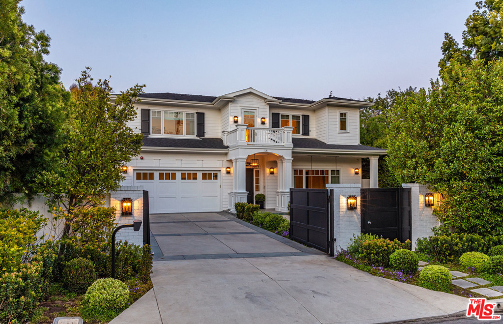 Situated in highly coveted Brentwood, this traditional residence opens with a light and bright hallway that visually draws owners to the lush backyard, while sunshine from spacious windows and designer touches throughout add class and warmth. First floor features a formal living room with fireplace, wood paneled library, formal dining room, guest room with ensuite bath, and exquisite chef's kitchen showcasing top of the line appliances and wine cellar. Family room shines with a gas fireplace and floor-to-ceiling windows and doors that open onto manicured rear grounds with a pool, spa, and outdoor kitchen. Upstairs, all 3 bedrooms feature ensuite bathrooms. A relaxing den provides a communal family space while the primary retreat is the ultimate in privacy with dual walk-in closets, an oversized steam shower, double vanity, and a soaking tub. Gated and hedged, this smart home is finished with a state of the art security system.