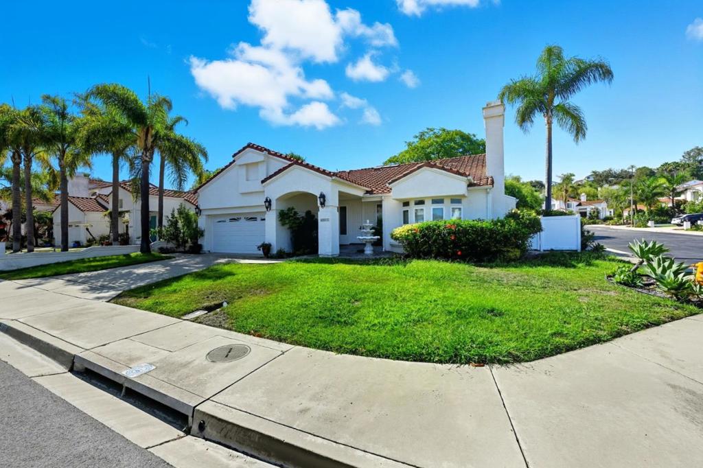 Nestled in the peaceful Southridge Estates community, this 3-bedroom, 2.5-bath home combines serene coastal living with refined style. A red-tile roof and fresh white exterior welcome you inside. The living room is anchored by a decorative fireplace framed in ornate molding, surrounded by tall windows. A crystal chandelier sets a graceful tone in the dining area, while the kitchen shines with polished counters, classic wood cabinetry, stainless steel appliances, and a central island. The sunlit breakfast space overlooks the backyard, a private retreat designed with low-maintenance landscaping, mature palms, and a raised deck perfect for outdoor dining or quiet evenings. Three bedrooms provide flexibility for restful retreats, a home office, or guest space, while 2.5 baths offer everyday comfort with luxury touches such as dual vanities, stone finishes, a soaking tub, and a walk-in shower. A 2-car garage with patterned flooring and built-in storage keeps life organized and functional. Living in Southridge Estates means being part of a calm, established neighborhood close to coastal parks, groceries, dining, and Oceansides relaxed charm. *One pet dog is allowed. *Pet weight limit is 20 lbs - if your pet exceeds this, please reach out to see if we can accommodate!