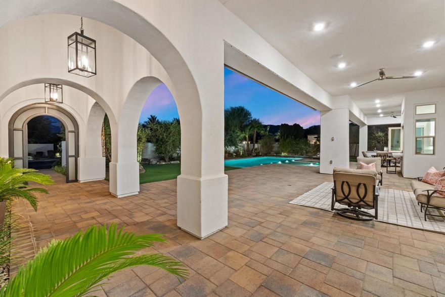 Griffin Ranch l La QuintaDiscover Ultimate Desert Living in La Quinta's most sought-after Residential Community. This expansive 4,154' residence, situated on a generous, almost 21,000' homesite, features 4 bedrooms - including 2 stately primary suites - plus an additional bonus room dedicated as a state-of-the-art golf simulator for true golf enthusiasts. The open floor plan is lite and roomy, evoking a casual, zen-like feel, ideal for relaxation. The calm and comfortable ambiance showcases tall, elegant, coffered-ceilings with decorative crown molding in both the great room and main primary, all seamlessly flowing onto a covered patio through large glass sliding doors. Enjoy ideal indoor - outdoor living with a considerable sparkling pool with spa and inviting large baja shelf - perfect for soaking in blue sky days and the southern winter sun while taking in phenomenal mountain views or entertaining family and friends. The impressive garage accommodates up to 4 vehicles or a mix of golf carts and desert toys, and features dual AC splits, custom cabinetry, and durable epoxy floors. Community amenities rival those offered at the best Private Clubs with pickleball, tennis, a Jr. Olympic pool, putting green, bocce, a modern fitness haven and casual clubhouse with seasonal events - plus 24-hour security and a remarkably reasonable HOA fee. Griffin Ranch is surrounded by the desert's finest Private Golf Clubs and top Resorts. These private clubs offer both social and golf memberships, facilitating the ultimate active, Desert lifestyle. Embrace luxury, recreation, and serenity - all in one exceptional home.