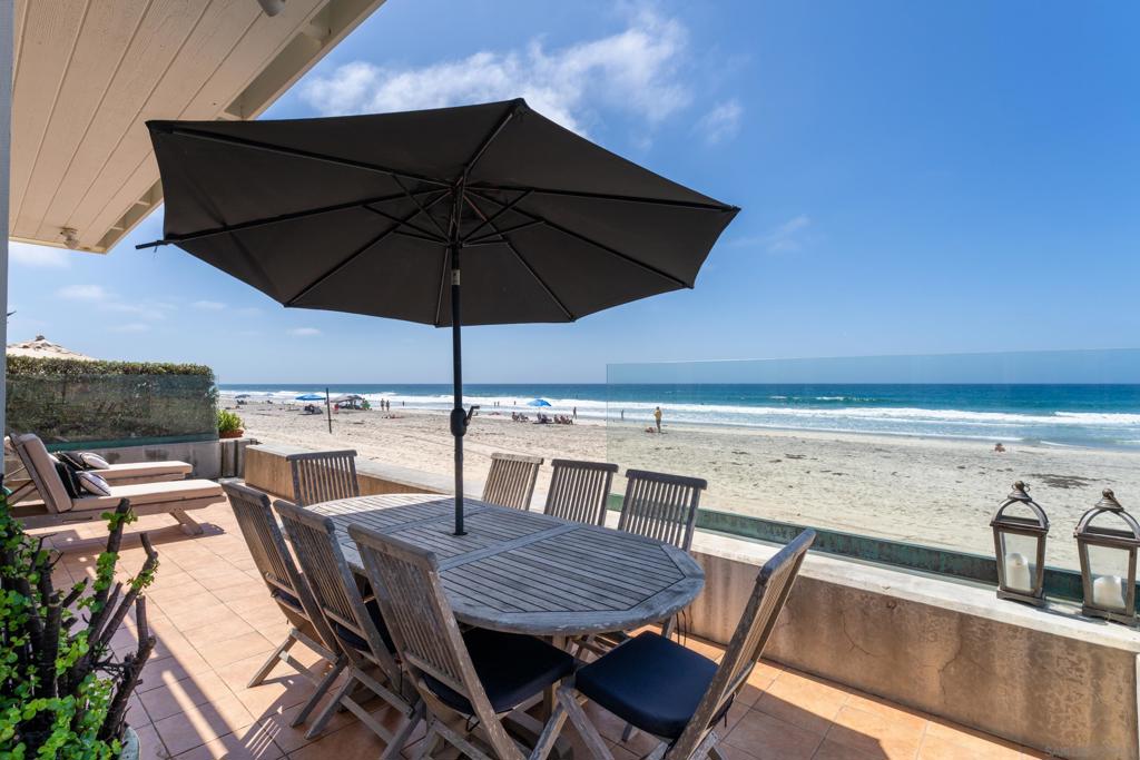 Life on the sand feels different. At 1836 Ocean Front, you wake up to the surf, wind down to sunset, and fall asleep to the steady hush of the Pacific. This is front-row beach living in Olde Del Mar, set directly on the sand between 18th and 19th Streets with a true walk-to-everything lifestyle. The three-level residence offers 6 bedrooms, 4.5 baths, and over 3,200 sq ft of versatile layout and uninterrupted ocean views. The lower level hosts a full kitchen, casual dining area and breakfast nook, plus a guest bedroom and full bath. The middle level frames wide ocean views from the main living areas. Sliding doors open to an oceanfront deck for meals, lounging, or a quick step down to the beach. A separate family room is ready for movies or games. Two interior courtyards add more intimate outdoor spaces, including an upper terrace and a lower brick patio. Upstairs, three bedrooms face the horizon and a view deck spans the full structure. The primary suite includes its own bath and walk-in closet, while two more guest rooms and a full bath sit above the garage, ideal for visitors or an office. The attached garage and wide driveway handle parking with ease. With a proven record as a vacation rental, the property generates solid cash flow and offers an ideal opportunity for a 1031 Exchange. Located one block from Poseidon, Jake’s, and Powerhouse Park, with Del Mar Village an easy stroll away, this address keeps dining, shopping, and everyday errands close while the ocean stays front and center. With the beach at your doorstep, daily life feels simple. The horizon does the rest.