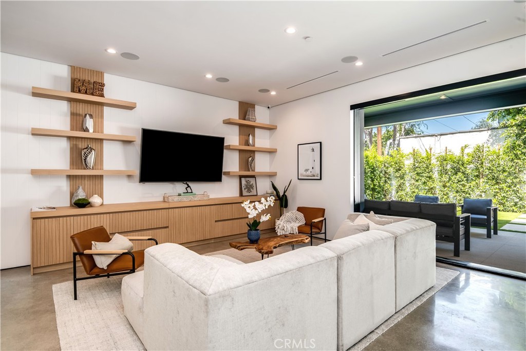 Introducing a stunning single-story modern farmhouse located in the serene and highly desired Sherman Oaks neighborhood. This meticulously rebuilt home boasts cutting-edge designer finishes, offering a bright and light-filled open floor plan spanning nearly 3,000 sq ft with 4 bedrooms and 4.5 bathrooms. The gourmet custom kitchen features top-of-the-line appliances, a large island with quartz counters, and exquisite attention to detail. The master suite offers a spa-like bath, a spacious walk-in closet, and direct access to the incredible yard. With seamless indoor-outdoor living, this entertainer's dream showcases large pocket doors leading to a private backyard oasis complete with a beautiful pool, spa, ample grassy yard, and entertaining space. Enjoy the utmost privacy and tranquility. Additional features include soaring 10 and 12-foot ceilings, an alarm system, and proximity to Ventura Blvd's shops and restaurants. Don't miss the opportunity to experience the best of the California lifestyle in this remarkable home!
