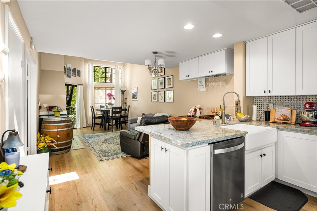 Live your best life in Morningside on the Lake!! **Upstairs LOFT can be used as a bedroom or home office** Plus a Main Level Primary Bedroom and Bathroom** One Car Garage & Covered Carport Space**LOW HOA Dues**Remodeled & Stylish Kitchen**Indoor Laundry Closet**Living Room w/Vaulted Ceilings & Open Floor Plan** Don't miss out on this beautiful condo in the highly desirable community of Morningside on the Lake. This hidden gem is tucked away on the outskirts of Old Towne Orange and a short distance to the restaurants and shops. One of the most popular floor plans in Morningside, enter on the second level and step into your new home with a primary bedroom and bathroom on the first level and an upstairs loft which is perfect for a home office. A stylishly remodeled kitchen is open to the spacious living room which has a cozy fireplace. The cheery kitchen includes white cabinets, fresh paint, a breakfast bar, granite counters, and stainless steel appliances. A one car garage and covered carport space ensures you have convenient parking. Other features include a brand new furnace, newer luxury wood vinyl floors, inside laundry closet, newer tankless water heater and an outdoor storage closet. Enjoy this secluded community surrounded by a tranquil lake, ponds, streams, waterfalls, and bridges. Overlooking the running streams, there is a balcony that is perfect for morning coffee or grilling on the BBQ. Cool off in the sparkling association pool and beat the heat! Nearby is Santiago Creek trail with walking and bike paths, Chapman University, the Orange Plaza, dining and annual events hosted by the City and Community of Orange like the International Street Fair, Christmas Tree lighting Ceremony, and Treats in the Streets in the fall. This one won't last so come on over and fall in love!
