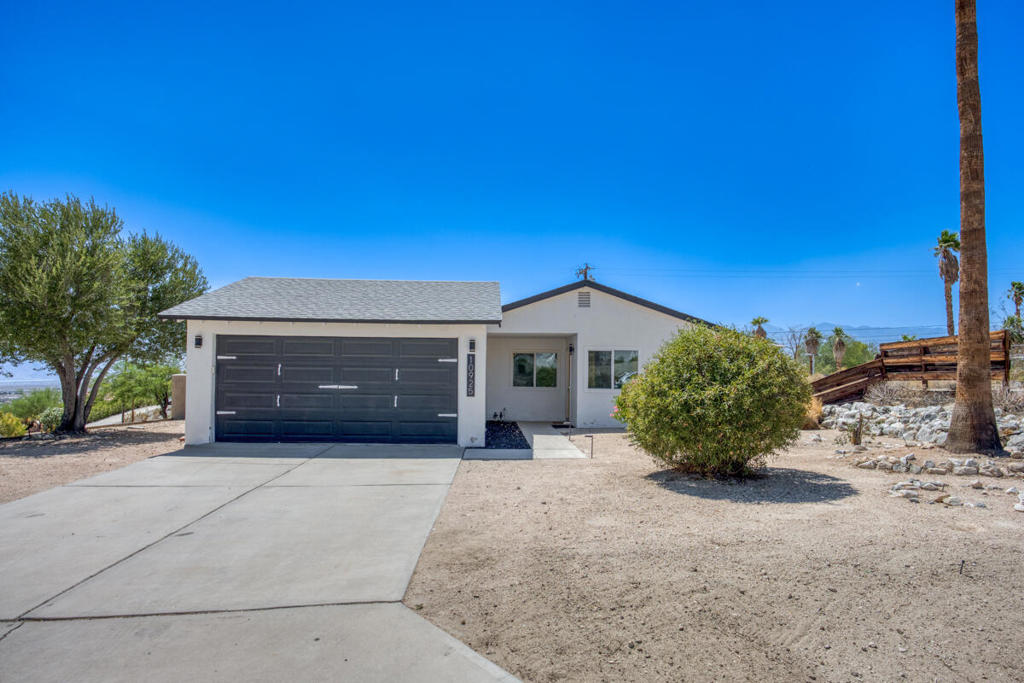 Stunning 4 bed, 2 bath vacation rental, pool home is ready to be made yours and features fantastic curb appeal, sitting on a corner lot with low maintenance landscaping, desert and city light views, and an on-trend yellow front door! The interior is open and spacious with lots of natural light, updates throughout, recessed lights, dual pane windows, a smart thermostat, and laminate wood-look flooring. The living room offers a slider to the side yard and flows into the dining area with slider to the backyard. The gorgeously updated kitchen sits just off of the dining area and offers granite counters, white cabinetry a feature wall, dark stainless steel range and dishwasher, and an included refrigerator. All of the bedrooms have ceiling fans and are generously sized the main bedroom features a private slider to the backyard and a private bathroom. Both of the bathrooms have also been updated and feature tile walls, modern vanities and fixtures. Enjoy the private backyard with mountain views, in-ground swimming pool and covered patio area, this is the perfect space for relaxing and entertaining guests! Conveniently located not far from shopping, dining, and more!