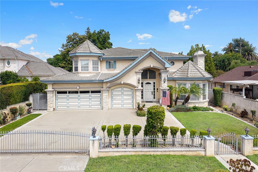 Welcome to this beautifully maintained 4-bedroom, 3-bathroom home located in the heart of Arcadia. Step into a grand formal foyer with soaring ceilings that lead into a spacious and light-filled living room and adjacent dining area—perfect for entertaining. The large kitchen features a center island and seamlessly opens to the inviting family room, where French doors provide direct access to a well-kept backyard ideal for outdoor relaxation. A convenient downstairs suite offers flexibility for guests or multi-generational living. Upstairs, the expansive master bedroom boasts a luxurious en-suite bathroom. Another generously sized bedroom shares a full bath, providing comfort and privacy for the whole family. Additional highlights include an attached 3-car garage, circular driveway for ample parking, and a thoughtfully designed layout perfect for modern living. Located near top Arcadia schools, parks, and shopping. Don’t miss this wonderful opportunity!