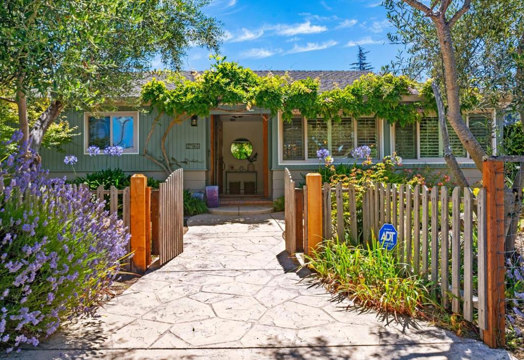 Nestled in the ideal micro-climate of mid-Carmel Valley, this elegant single-level home offers a perfect blend of privacy and gracious living. Impeccably maintained inside and out, the property features lush grounds dotted with fruit trees and inviting private patios. The newly renovated kitchen is a delight for entertaining, whether hosting indoors or al fresco. Upon entry, youre welcomed by a spacious living room with a charming Carmel stone fireplace and an atmosphere of warmth and sophistication. The thoughtfully designed floor plan includes a separate bedroom wing with its own cozy dencomplete with sliding doors that open to the backyard patio and serene views of the Carmel Valley hills. A generously sized two-car garage and ample parking add to the homes convenience. Ideally located close to shopping and all the charms of Carmel Valley living, this turnkey property is ready to welcome you home.