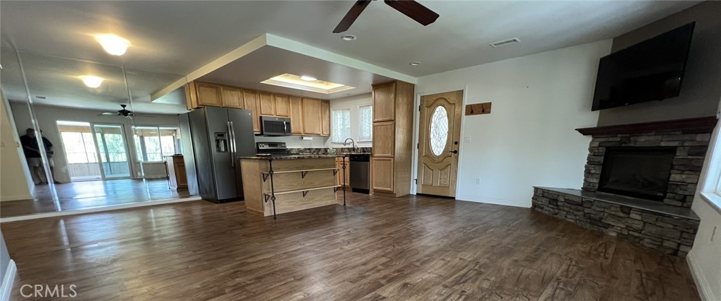 Beautiful two-bedroom, two-bathroom unit available in a quiet end of Laguna Woods. Luxury vinyl flooring throughout with an enclosed balcony for extra space. Open concept kitchen and living room with multiple skylights throughout the home. Granite countertops throughout the kitchen, with a large kitchen island. Beautiful built-in custom cabinetry with leaded glass and granite counters in the secondary bedroom along with a built-in fireplace. Ceiling fans in all rooms. Large built-in fireplace in living room. Full wall mirrored dining room area. Multiple and ample storage spaces. Stackable washer and dryer. Central heating and air conditioning. Assigned carport with storage.