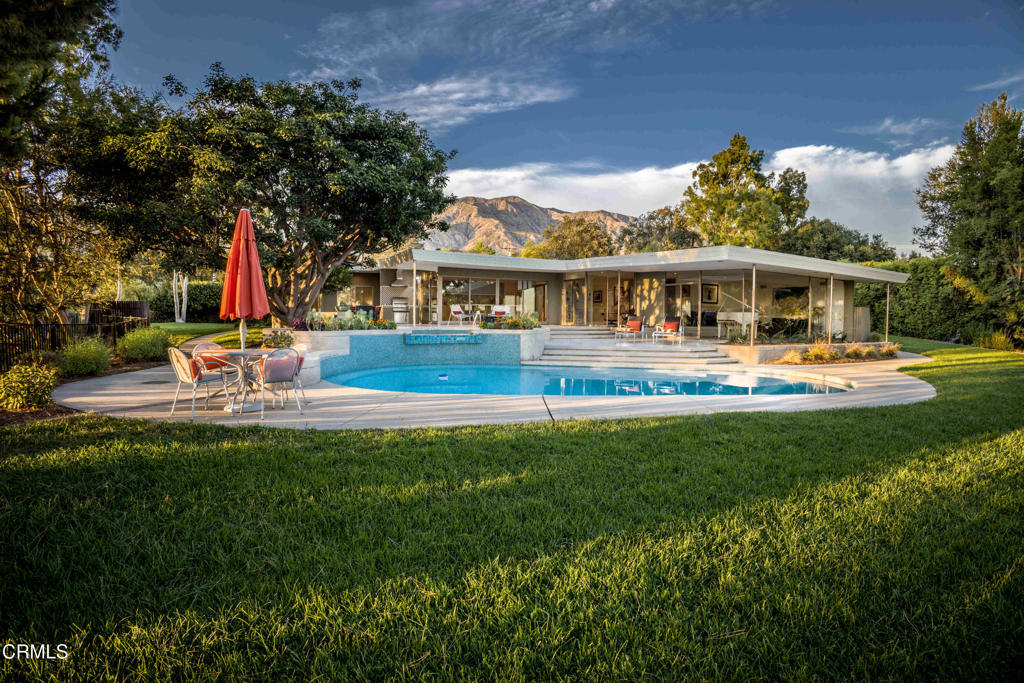 A Mid-Century Masterpiece with City Lights and Mountain Views - Set on over an acre lot in Pasadena's coveted Sierra Madre Villa neighborhood, this expansive 5-bedroom, 5-bath residence spans 3,971 sq. ft. of living space and was designed by renowned architect Harold B. Zook--celebrated for the Saga Motel and numerous mid-century landmarks. With sweeping city light and mountain views, the property blends architectural pedigree with modern sophistication in a rare, private estate setting.At the heart of the home, the kitchen was completely reimagined in 2021, designed with modern, flat-panel cabinetry, integrated appliances, and seamless soft-close storage. Luxe Dekton slab countertops provide both durability and elegance, while the space is outfitted with a Sub-Zero refrigerator, Wolf stainless steel microwave, gas cooktop, double oven, and a Miele dishwasher. Newer dual-pane sliding doors extend the kitchen onto a freshly polished marble patio, creating a flawless indoor-outdoor flow framed by panoramic Pasadena views.Throughout the living room, bedrooms and kitchen, light-toned engineered hardwood floors bring warmth and modern texture. Additional updates include dual AC units, a newer furnace, a newer sewer line, and a resurfaced pool finished in brilliant aqua-blue tile.For security and curb appeal, the property features new perimeter fencing, a contemporary motorized gate, a paver driveway, and a spacious three-car garage.Set high above the city, 1215 Wynn Road is more than a home--it's an architectural statement, a private retreat, and a rare opportunity to own a Zook original on an acre-plus estate in one of Pasadena's most distinguished settings.