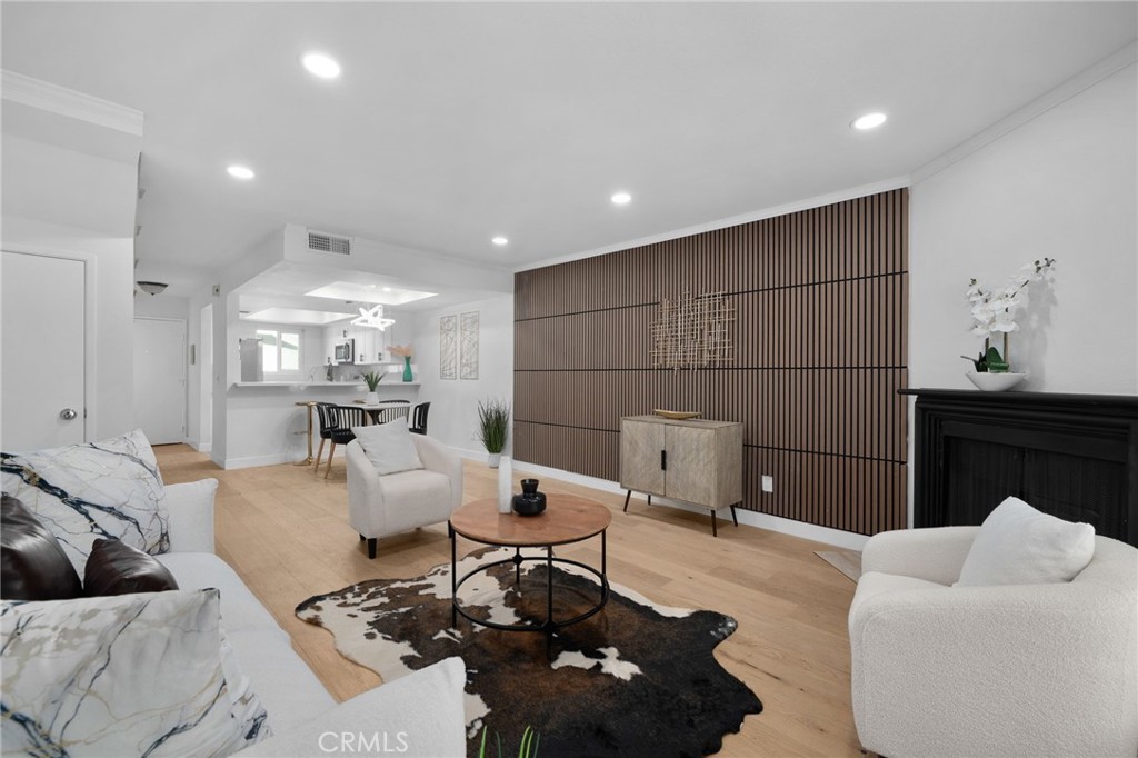Welcome to this stylish and spacious 2-bedroom, 2.5-bath townhouse-style condo in a gated community in the heart of North Hollywood! This bright and airy home features an open floor plan with a combined living and dining area, warm wood floors, a cozy fireplace, and high ceilings with recessed lighting. The kitchen offers breakfast bar, and stainless steel appliances, perfect for daily living and entertaining. Both bedrooms have their own bathrooms and lots of closet space. The primary suite includes a walk-in closet and a private balcony. You’ll also enjoy in-unit laundry, central A/C, and two side-by-side gated parking spots in a secured garage. The well-maintained complex has controlled access, guest parking, Pool and Gym, It’s just minutes from the NoHo Arts District, major studios, restaurants, shopping, and public transportation. A perfect mix of comfort, convenience, and location, don’t miss the chance to make this North Hollywood gem your new home!
