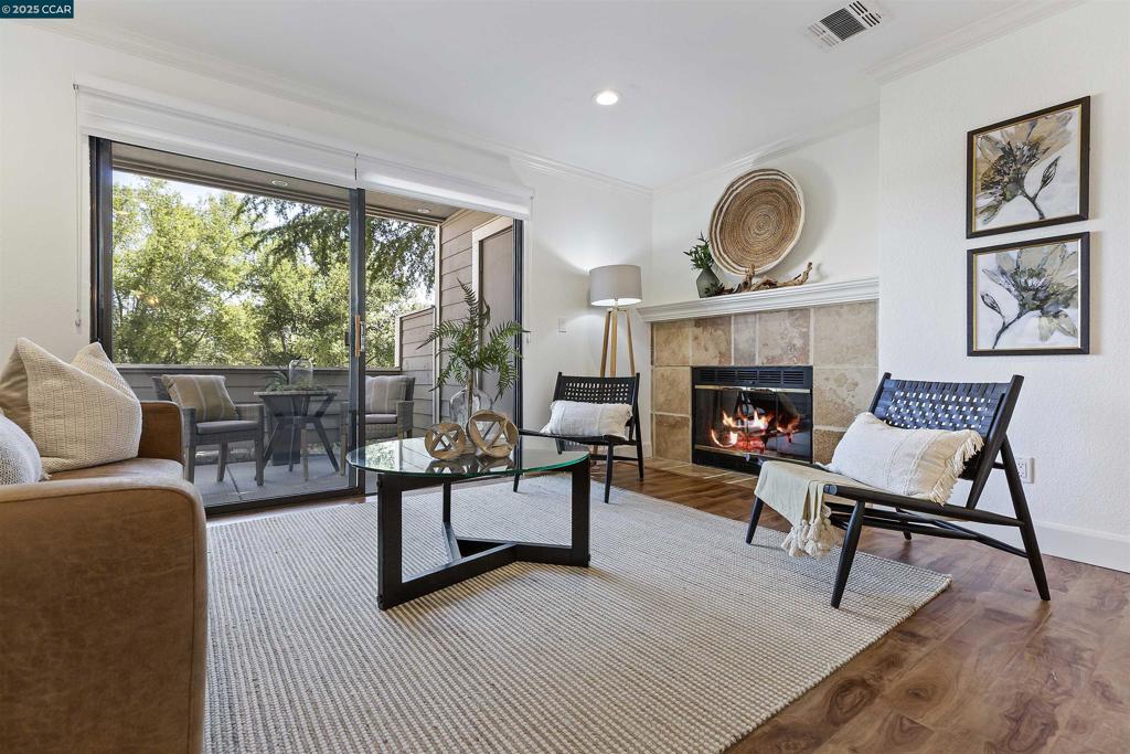 Nestled in San Ramon's exclusive, gated Crestview community, this stunning one-bedroom, one-bath condo offers a peaceful retreat with all the creature comforts you need. With its level-in entry, spacious living areas, a generous private patio, and a rare location tucked away against serene open space, this home is head and shoulders above the rest. From the elegant plank flooring and crown molding to the wood-burning fireplace to custom window treatments …it feels both modern and welcoming! This beautifully maintained property has been recently painted throughout and is move-in ready! Large windows throughout provide lovely natural light. The highly functional kitchen features granite countertops and opens on to a cozy dining area. The oversized primary bedroom is steps away from the in-unit laundry closet and the attractive bathroom with a tub-shower combination.The carport and sparkling community pool are close by. Enjoy easy access to Highway 680, shopping and schools.