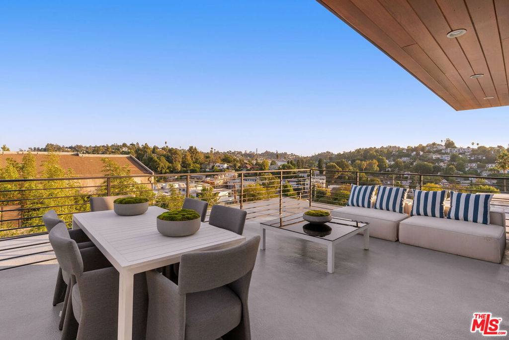Embrace contemporary living at 2915 Avenel Terrace, just moments from Ivanhoe Elementary. This modern home features a spacious great room ideal for entertaining, complemented by a gourmet kitchen with an inviting island, elegant walnut cabinetry, and high-end Bertazzoni appliances. With three generous bedrooms, each equipped with its own ensuite, you'll find comfort and privacy throughout. The primary and secondary bedrooms both boast large walk-in closets. The luxurious primary bath includes a freestanding tub, stylish ceramic tiles, and dual vanities. Enjoy added convenience with laundry in-unit and a private 2-car garage. The rooftop deck offers stunning views of Silver Lake Reservoir, Downtown's skyline, and Griffith Observatory, framed by the vibrant neighborhood. Located near the dining and shopping options of Hyperion and Rowena Avenues, with Griffith Park and Los Feliz nearby. Utilities are the tenant's responsibility. Lease terms are 6 months to 1 year, with a lease-to-buy option available. Property is available fully furnished and with utilities included for $14,000 per month.