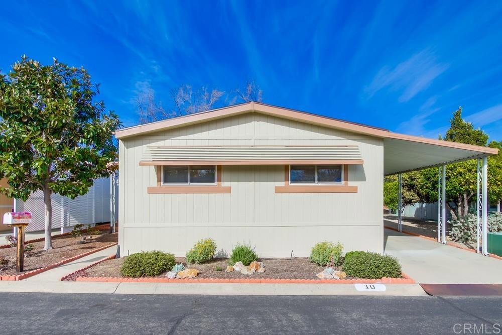 Excellent opportunity to OWN THE LAND in a gated 5 Star 55+ community. Clean & very well maintained 3 BR home with main suite at opposite end from guest rooms. Vaulted ceilings, dual pane windows, central A/C & large porch with gentle breezes make this home comfortable year-round. Roof replaced in 2018. Walk-in shower plus walk-in tub for ultimate accessibility. Located a short walk from the main clubhouse, pool & guest parking. Covered driveway with room for 3 cars. Low HOA of $302 per month includes all amenities, trash, sewer, cable & water! This is the ultimate community for active seniors. Friendly neighbors, fun activities, 2 pools, 2 clubhouses, lovely greenbelts with mature landscaping, walking distance to transportation & shopping. RV parking is available for $75 mo. This is the best value 3 BR land-owned home in North County. Come see it today!
