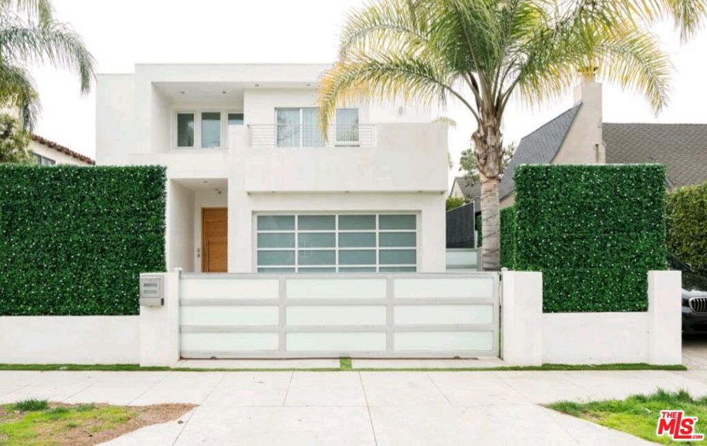 Welcome to this gated and updated contemporary pool home set behind privacy walls in a highly sought-after Beverly Grove neighborhood close to many of the area's attractions, shopping, dining, nightlife, and more. Discover on-trend finishes, open light-filled spaces, and wood floors throughout. The living room features an elegant stone ledge plus fireplace, and the adjacent kitchen has a center island with cooktop and an abundance of glossy cabinetry. Folding glass doors open to the rear grounds, perfect for al-fresco dining and entertaining with an easy indoor/outdoor flow. The nearby formal dining room has a huge floor-to-ceiling picture window framing greenery outside. The spacious primary suite includes a decorative gas fireplace, sumptuous spa-inspired bath with separate tub and shower, and a balcony. Other bedrooms and bathrooms are also well appointed, and a loft-style office/bonus space is versatile with a variety of uses. In the backyard, discover a fire table, pool, spa, poolside shower, and ample patio space to relax and barbecue. Centrally located close to the Beverly Center, Cedars-Sinai, Miracle Mile's museums, The Grove and Original Farmers Market, West Hollywood, and the shopping of Rodeo Drive in Beverly Hills.