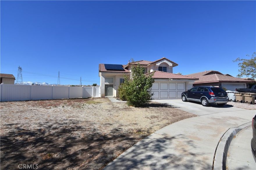 4-Bedroom Family Home with Paid Solar in a Peaceful Cul-de-Sac. Welcome home! This four-bedroom, three-bath home sits on a quiet cul-de-sac and is close to parks and the California Aqueduct, where you can enjoy biking, walking, jogging, fishing, and beautiful views. With some paint and handy work, this home can be an excellent home for the family. You will see drywall damage in the upstairs and downstairs ceilings from a past leaking condenser drip pan.  The home features a paid solar system, helping you save on energy costs year-round. Inside, the bright living room offers high vaulted ceilings and a cozy fireplace, creating a warm and welcoming space for family gatherings. The open country kitchen has plenty of cabinet space and a large dining area perfect for meals and memories. Downstairs, you’ll find a bedroom with double doors that can easily be used as a home office, guest room, or in-law suite. Step outside to the spacious backyard, ideal for weekend BBQs, playtime, or simply relaxing. A custom storage shed is also included for all your extra belongings.