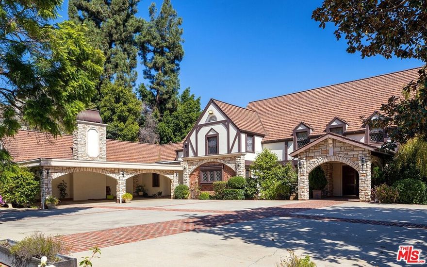 Spectacular development opportunity. Beautifully situated at the corner of Ladera and Monovale Drive in Holmby Hills, this 1.6-acre property offers unlimited possibilities. A long private drive leads up to a motor court and a stately Tudor Revival house with leaded glass mullion windows, imposing archways and high-pitched roof.