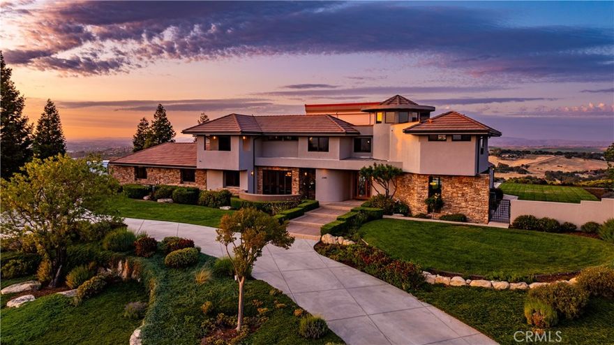 Welcome to one of the most exclusive estates in Templeton’s highly coveted Santa Ysabel Ranch. This breathtaking 5,706 sq ft residence is nestled on over 2.25+ acres of land, offering unparalleled panoramic views from the top of the hill. Designed for those who demand the best, this property boasts exceptional craftsmanship, luxurious features, and an unbeatable location. Some key features include a luxurious primary suite along with four additional bedrooms – all with en-suite full bathrooms - offering comfort and privacy for family or friends. The gorgeous maple wood floors and custom woodwork throughout highlight the fine craftsmanship and attention to detail. Enjoy hilltop views from your Chef’s dream kitchen, featuring custom curved cabinetry, sub-zero refrigerated drawers, a hidden walk-in pantry, center island and all top-of-the-line Miele appliances. A built-in espresso machine at the kitchen coffee station makes your mornings even more enjoyable. The living room is highlighted by views of the pool and rolling hills, with an impressive gas fireplace for added warmth and ambiance. The living room bar, featuring custom angled cabinetry and beverage refrigerators, is perfect for entertaining. The office/gym with cork flooring is ideal for work or play. Additional conveniences include a powder room on the main living level for guest use, elevator and a laundry chute. The impressive 5-car garage showcases custom wood doors, a workshop space, a half bath, plumbed-in air compressor, custom tool slat-wall storage, and underlit, wall-hung cabinetry. It even has its own heater for year-round comfort. The garage's half bath opens directly to the yard, providing convenient access to the pool area. The infinity edge, solar-heated pool has a spacious hot tub, and is surrounded by lush, mature landscaping - including gated walkways and beautiful Redwood trees. A Bocce court sits below the pool. The exterior patio space with expansive concrete and hardscape is ready for your summer entertaining. There is even a hidden, custom storage room for your pool equipment and furniture in the off season. This is truly a once-in-a-lifetime opportunity to own one of the most exceptional properties in the Santa Ysabel Ranch community. Whether you're entertaining in style, enjoying breathtaking views, or simply relaxing in your own private retreat, this home offers the best of all worlds.