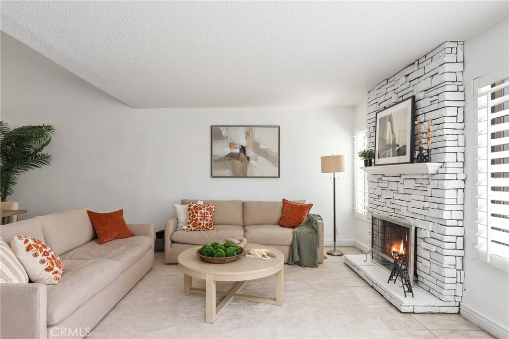 Welcome to this stunningly upgraded two-story townhome, perfectly situated on a spacious greenbelt in the heart of desirable Heritage Park. From the moment you step inside, you’ll fall in love with the inviting ambiance — soaring cathedral ceilings, a romantic fireplace, and a light-filled living room that exudes cozy elegance. The beautifully remodeled kitchen is a chef’s delight, offering sleek finishes, ample storage, and effortless flow for entertaining. Upstairs, generous bedrooms provide comfort and privacy, making this home as practical as it is charming. Step outside to your own private oasis — an entertainer’s dream patio featuring a large wrap-around bar, built-in BBQ, and plenty of space for unforgettable gatherings under the stars. Additional highlights include central A/C, a 2-car garage, and access to top-tier amenities just a short stroll away: sparkling community pools, award-winning blue-ribbon schools, an expansive park with sports courts, a vibrant arts center, a modern library, and a world-class aquatic complex. Low HOA, NO Mello-Roos, and move-in ready — this is the one you've been waiting for. Don’t miss it!