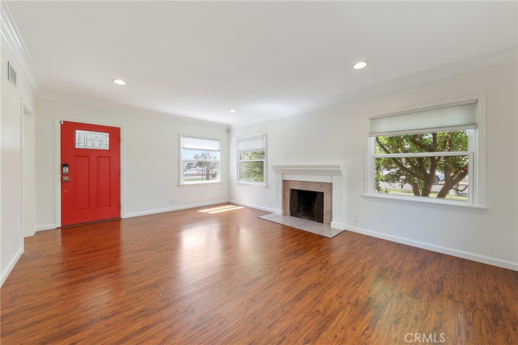 SINGLE-STORY CHARMING HOME WITH A PEACEFUL OUTDOOR HAVEN! Perched along a tree-lined street, step inside this quaint property and immediately notice the open and airy living spaces highlighted by a multitude of windows for exceptional natural light. Step right into the living area featuring a fireplace, perfect to cozy up to on the coming cold nights. The separate dining area opens up to the kitchen, perfect for entertaining guests. The kitchen is well equipped with granite countertops, stainless steel appliances and plenty of cabinets for storage. Freshly painted interior throughout for the lucky next tenants! Wood flooring throughout. 3 sizeable bedrooms with the primary suite directly opening up to the spacious backyard. Enjoy the serene oasis without the hassle of maintenance as gardening is included. Washer and dryer conveniently located in a separate room inside the property. 2-car detached garage with a long driveway and ample street parking. Conveniently located by many shops, markets, restaurants, schools and easy access to the 57 or 5 freeways. Short drive to Downtown Orange with great restaurants and bars.