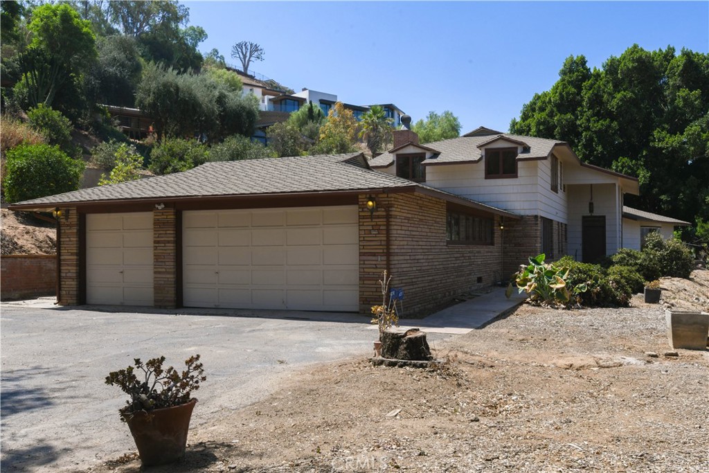 Don't miss this unique opportunity to own 1.77 acres in Knob Hill in the city of Riverside with a 3,310 sq ft home that was custom built in the 1940's; a charming, historically rich home on a large lot in Riverside. It combines traditional architectural details with updated amenities.
Gated with a long, private driveway, this home features a grand entry foyer; showcasing a large picture window with views, a traditional staircase, and a dramatic chandelier
The formal living room boasts wood flooring, a beamed ceiling, a wood-burning fireplace, and a panoramic bowed window with paneled glass.
A slump stone fireplace adds character to the family room, complemented by an adjacent sunny patio room with flagstone flooring and ample windows.
The Great Room: Versatile in nature, this room features hardwood floors and a statement chandelier, historically used as a formal dining room with double doors leading to a sunroom.
The kitchen has new laminate flooring, ample cabinetry, and granite counters, and includes a charming breakfast room. A brick hearth serves as a focal point, providing warmth and ambiance plus a walk-in pantry and a basement
Around the corner from the kitchen, a Butler's staircase offers a secondary access point to the upper level. Indoor laundry room with deep-well basin and a guest bath.
Two bedrooms are situated on the main floor, each with its own private bathroom. One of these bedrooms offers double closets and a walk-in wardrobe.
The second level features a well-proportioned secondary bedroom with shutters and built-in features, and a full bathroom. The primary bedroom includes an ensuite bath, a walk-in closet and a separate sitting room or storage area.
The property features multiple patio areas perfect for entertaining and garden parties, along with a terraced garden and loads of acreage to do as you please.
This custom-built Riverside home offers a blend of vintage charm and modern conveniences on a large, secluded lot. This home has been owned by the same family since it was built in 1947. Come take a look at this piece of Riverside history.