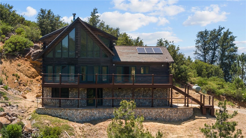 Experience all four distinctive seasons in this gorgeous mountain retreat with views galore. Nestled in the Cuyamaca woods neighborhood of Julian, this well-maintained log home features off-grid living that is 100% solar-powered with a backup generator and shared community well, no SDGE bills ever!!! Three levels, 20’ ceilings, a chef’s kitchen, and generous square footage will never leave you feeling confined. Majestic views from the large outside deck or through the floor to ceiling windows allow you to enjoy the scenery through all four seasons. The top two floors, containing three spacious bedrooms and two bathrooms are 1,747 square feet; but the 600 sq. ft. ground-floor level has recently been turned into a studio unit with laundry bath and kitchenette to either have a great bonus room or rent out and increase the living area to approximately 2,300 sq. ft. There is also an attached 2 car garage. Tremendous opportunity awaits with the owner also selling the neighboring vacant lot to the buyer at a discount if they wish to have nearly 5.25 acres of land. Recent upgrades include mew maintenance free batteries for off grid solar system, replaced motherboard on Inverter, complete paint inside, new toilets, hardwood stairs, LVP bedrooms, Staining outside of home, new paint on front deck and stairs and new wire railing with wood pillars, back deck new paint, and everything in studio, W?D dishwasher fridge, farmers sink, central heat and garage floor redone