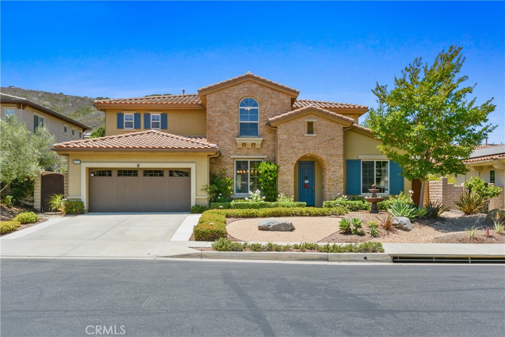 Rancho San Juan's gated community of Whispering Hills in the hills of San Juan Capistrano. Excellent inside tract location on quiet street, this beautiful home features 5 bedrooms, 4.5 bathrooms, along with formal office, loft area, bonus family room. Bi-fold doors open to covered outdoor California room with built-in fireplace, huge private grass backyard with fruit trees, definitely large enough to have a pool. Inside features: custom tumbled travertine flooring, formal dining room, butler pantry, gourmet kitchen with large island for entertaining, light breakfast nook area, upgraded cabinetry, large family room with fireplace and bonus area for entertaining or a pool table, vaulted ceilings, one bedroom and bath downstairs, upstairs has good size secondary bedrooms, loft area with built-in desk, laundry room, primary suite with fireplace, primary bathroom has separate tub and shower and dual vanities, along with walk-in closet. Additional upgrades include recently added new windows throughout, also has fully owned solar. This home is absolutely beautiful and turn-key. Walking distance to San Juan Hills High School. Gate community has tennis courts, picnic area, and playground, along with walking trails. Close to all South County has to offer.