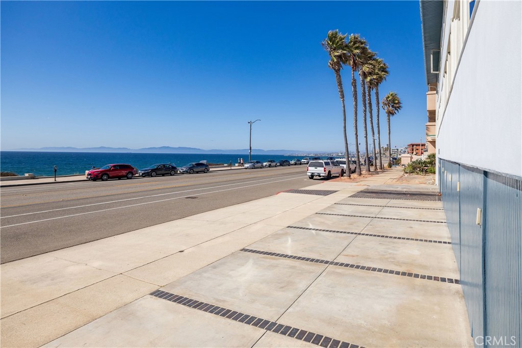 BREATHTAKING OCEAN VIEWS! Corner Unit! This two-bedroom, one-bathroom condo in South Redondo Beach is a true coastal sanctuary. Enjoy panoramic 180-degree ocean views spanning from Palos Verdes to Santa Monica, just moments from the sand. The residence showcases a designer kitchen with custom cabinetry and granite countertops, complemented by hardwood floors throughout. Modern upgrades include automated roll-up blinds in the living room, blackout shades in the bedrooms, and ceiling fans for year-round comfort. The open-concept living area embraces the sweeping views, creating a bright and inviting atmosphere. A shared courtyard-style patio in the back offers a relaxed outdoor retreat with a barbecue area, perfect for lounging or casual gatherings. Additional highlights include three parking spaces, including a dedicated garage, and a prime location just minutes from the Hollywood Riviera’s shops, cafés, and restaurants. Experience the best of South Bay coastal living in this immaculate, move-in-ready home!