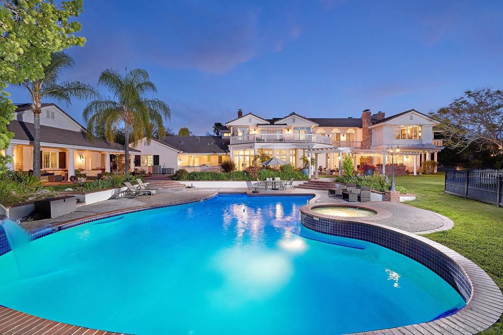 Stunning Custom Estate with Luxury Amenities on 2 Acres in Gated Community. Welcome to this exceptional 11,041 sq ft estate, featuring 7 spacious bedrooms, 7 1/2 baths, and an array of impressive features. This home boasts 2 media rooms, 2 private offices, and an in-law suite with its own bedroom, bath, office, and living room, perfect for multi-generational living. A full gym is attached, offering a great space for fitness. For movie lovers, the home theater with seating for a large audience is sure to impress. The remodeled gourmet kitchen is a chef’s dream, complete with a Viking 42-inch refrigerator/freezer, 6-burner gas cooktop, double Viking ovens, built-in microwave, dual dishwashers, large walk-in pantry, and two sinks for ultimate convenience. The expansive 1,100 sq ft game room is a great space for entertainment and can easily be converted into a guest house with the addition of a kitchen and bath. The property also features a 4-car garage with the potential to expand to a 6-car or even a 10-car garage. Step outside to a backyard oasis, complete with an oversized pool with a slide and hot tub, a freshly resurfaced tennis/pickleball court and a basketball area. The grounds also include over 30 fruit trees, a large garden area, extensive terraces and decks for outdoor living, and a well for irrigation. Owned solar panels, a low HOA fee, and the security of a gated community make this estate even more desirable. The master suite is a luxurious retreat, offering a generous sitting room and office space with a grand fireplace, and panoramic views. The property also features a 4-car This exceptional property has been extensively remodeled just 4 years ago, it offers an unparalleled lifestyle in a prime location.
