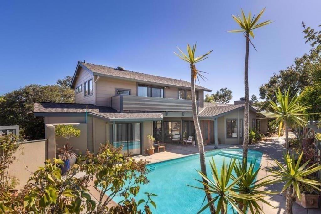 Nestled in the heart of Monterey's sunbelt stands a truly remarkable multi-family home. Positioned on a corner lot with a cul-de-sac, this property promises to capture the hearts of those seeking a versatile and charming abode. First time on the market, this home was originally built in 1950 as a quaint 3 bedroom, 1 bath residence. A profound testament of resilience and growth, this home now includes 6 bedrooms, 4 baths, 2 kitchens, 3 living rooms, 2 car garage, an in-ground swimming pool, laundry room, limitless storage and an abundance of unique features just waiting to be discovered. Every corner of this home tells a story. The main floor was reimagined to offer an engaging connection to the outdoors, where most rooms open to a private walled oasis. The former art studio, now a cozy guest unit, warmly welcomes visitors with a private entrance from the driveway. Ascend to the upper level where a charming separate living unit boasts a grand walled balcony, overlooking the pool and courtyard below. Expertly upkept, this 2,700-square-foot treasure stands unmatched. With unlimited potential for your own family's story, this captivating blend of history, beauty, and functionality beckons to those seeking a home that embraces the past, thrives in the present, and welcomes the future.