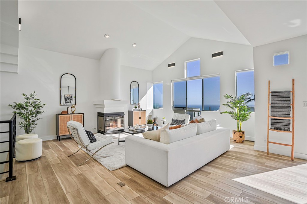 This contemporary townhouse looks amazing, and we think you'll agree! We just finished an extensive remodel and love how it turned out! Live just steps from the sand in this west facing gem with panoramic white water ocean views. But come see for yourself! Most of the lighting has been replaced with contemporary matte black fixtures. This theme has been carried into the new luxurious master bath with black matte fixtures in the soaking tub and walk-in shower. The entry foyer has ocean views as the does the master suite and second bedroom. Come upstairs (black matte handrails & new low pile charcoal carpet stairs) and be blown away the huge expanse of windows and the panoramic ocean views. Sit at the breakfast bar or have a sip of wine on the outside deck...this is a great place to entertain. There's a wine refrigerator in the stylish kitchen with stainless steel appliances. And if you like to surf, you are close to what is considered one of Southern California's best surfing locations! Parking is easy...2 side by side spots in the secure gated garage plus another dedicated parking space on Crest Drive. Low HOA dues. This home is located in Manhattan Beach's very desirable north end, close to great restaurants, the Strand, shops, and award-winning schools. LAX and the freeways are nearby. This is more than a home...It's the coveted Manhattan Beach lifestyle.