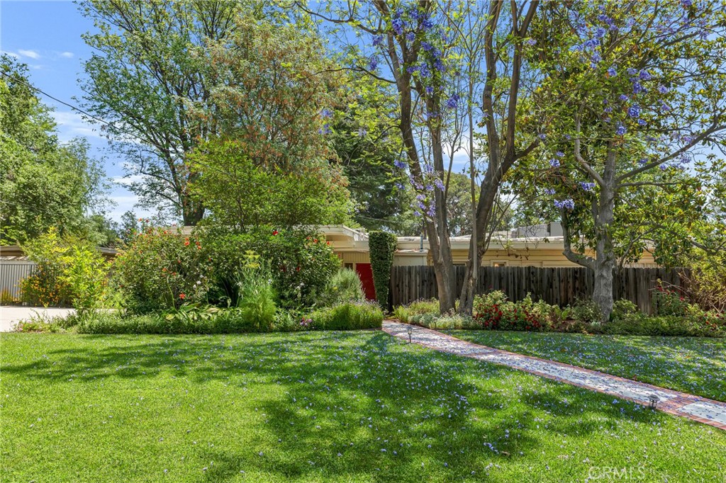 A Rare Chatsworth Gem, this Historic Mid-Century Modern home on a 1/2 acre lot. Welcome to 9700 Nita Avenue – a truly one-of-a-kind property steeped in history and set in one of Chatsworth’s most tranquil and private enclaves. This original house, once home to Nita herself (the namesake of the street), offers nearly 2,600 sq. ft. of timeless character and distinctive mid-century modern charm on a sprawling half-acre lot. This uniqure set up feels like a private artists retreat, a writers dream setting. This peaceful serene setting has so many possibilities, feels like a double lot, privacy galore among towering trees and lush landscaping.
Featuring 4 spacious bedrooms plus office, basement and 3.5 baths, this home is designed for comfort, style, and serenity. From the moment you arrive, you’ll be captivated by the peaceful surroundings and lush natural setting. Inside, clean architectural lines, large windows, and organic materials create a seamless connection between indoors and outdoors, Floor to ceiling walls of glass in the livingroom and family room with a view of the peaceful fountain.
Whether you’re enjoying quiet mornings in the sun-soaked family room, entertaining guests in the open dining area, or relaxing in the expansive backyard oasis, this property offers a lifestyle of understated luxury and historical significance. Expansive driveway, RV access, 2 car detached garage plus a large workshop area.
Don’t miss this rare opportunity to own a true piece of Chatsworth’s heritage—where privacy, history, and architectural integrity meet. First time on the market in over 60 years.