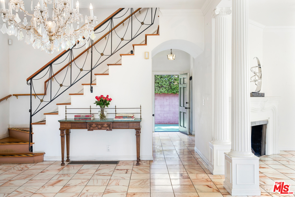 Street lined with palm trees captures the charm of this stunning 1920s Spanish Colonial Revival located in the flats of Beverly Hills. Escape into this private retreat with 5 BD + 5 BA, a private 1 BD + 2 BA guest house, 3 car garage, singles tennis court, pool, and cabana on a 22,669 square foot lot. High ceilings and large windows that allow natural light to flow throughout the home with a dramatic foyer leading to a grand living room with Marble floors and columns. The scale of the rooms are spacious and surrounded by a tranquil setting. Separate breakfast area and classic dining room with Ornamental ceilings. Enjoy hosting in the wood paneled room with a full bar, that is reminiscent of a Speak Easy. Outside the sliding glass doors choose between a romantic patio for alfresco dining or a huge pool and gazebo. Spacious circular driveway to accommodate your guests. Conveniently located to Beverly Hills stores and restaurants on Rodeo Drive, right outside your door.