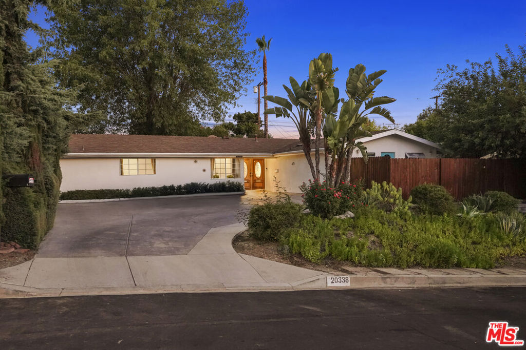 Style, form and function unite in this exceptionally redesigned Mid-Century ranch in Woodland Hills' coveted Carlton Terrace. Crowning a near acre lot on a peaceful, serene cul-de-sac, the property resides in divine harmony with its organic surroundings of towering trees and sprawling lawn. Updated with the design and amenities ideally suited for today's contemporary lifestyle of easy, relaxed living and entertaining, the home features an appealing open floorplan that provides gracious transition from room to room. Wood floors grace the living areas. Recessed lighting glows throughout the home. Remodeled baths feature fine lighting, fixtures and finishes. The modernized open kitchen is optimally designed for the adventurous at home chef and features an array of fine stainless steel appliances. Adjoining the dining room, it's the perfect gathering place for friends and family. Glass sliding doors bring the outdoors in and give way to a covered patio and newly sodded sprawling back lawn perfect for endless al fresco leisure and limitless outdoor entertaining. Highlights include a fully permitted ADU built in 2022 with private entrance and patio offering a myriad of possibilities! Located in the Calvert Charter School for Enriched Studies with proximity to the chic shopping and dining of the beloved Topanga Village, this residence of timeless style and enduring appeal is the place where you want to live. Welcome!