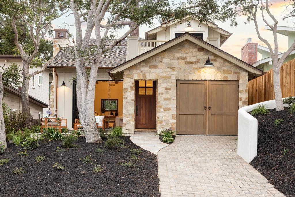 Brand new and built from the ground up, this Carmel-by-the-Sea residence combines timeless craftsmanship with modern design. Situated on a quiet stretch of Mission Street between Santa Lucia and 13th Avenue, the home offers both tranquility and convenience, with a straight stroll down to the beach or an easy walk into town. The two-story design features floor-to-ceiling windows that bathe the interiors in natural light. The main level features wide-plank oak floors, a luxurious primary suite with quartzite finishes, eight-foot alder doors, and an open, airy layout that combines comfort and elegance. Take in beautiful views of the Mal Paso hills and Carmel's historic water tower from the upstairs bedroom. Other highlights include a laundry room and attached garage, forced air heating with a dual-zone furnace, copper gutters and downspouts, and handcrafted alder doors, all of which reflect the care and quality of this new construction. With its seamless blend of modern amenities, refined finishes, and an ideal location, this home offers a rare turnkey opportunity to enjoy the Carmel lifestyle in style and comfort.
