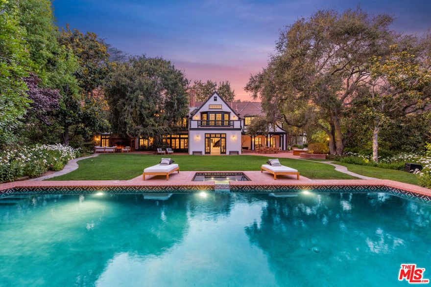 The Steven Bochco Estate by famed architect Paul Williams, situated on a double lot comprised of nearly 1.4 acres, is the most exquisite offering on the market today. Through the gates and surrounded by an irreplaceable masonry wall and lush landscaping, the level of privacy is unmatched with park-like grounds that include an incredible pool and spa, cabana, guest house, expansive yard and tennis court. This newly renovated estate features an entertainer's floor plan that flows seamlessly into each room with an abundance of natural light. Highlights of the main residence include a gourmet chef's kitchen, stunning library, formal living room, family room with projector screen, and a private guest apartment wing. The primary suite has gorgeous vaulted ceilings with dual bathrooms and walk-in closets. This trophy estate is an architectural masterpiece in the most prime area of Los Angeles to create the ultimate compound in the Riviera.