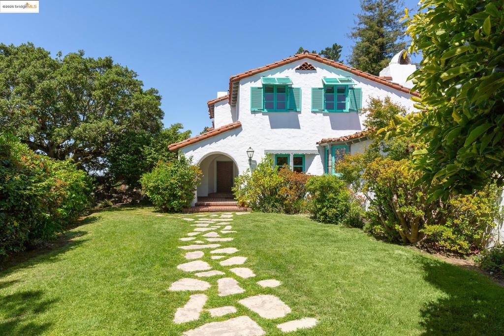 Level-entry to this bright and beautiful home with timeless architecture surrounded by expansive gardens of more than half an acre. Spectacular living room opening to broad terrace with Bay Views. Formal dining, library, kitchen/family room, ½ bath and bedroom suite on the main level. 4 bedrooms and 2 bathrooms on the upper level. A separate bedroom and bath has served as a great guest suite. 3 car garage! and guest parking. This is truly a beautiful home with artisan details and privacy throughout. Lovely, quiet neighborhood!